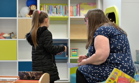 Girl in library with librarian
